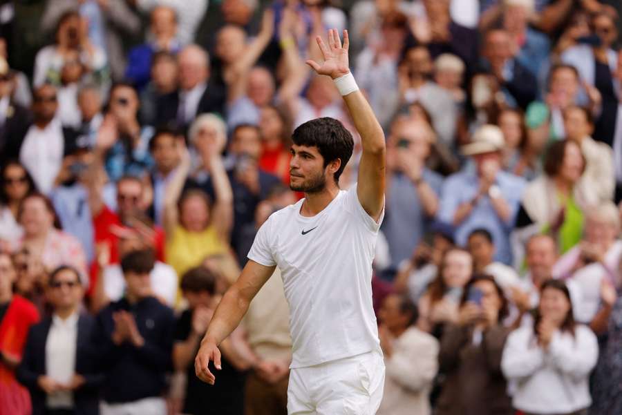 Carlos Alcaraz celebrates after winning at Wimbledon