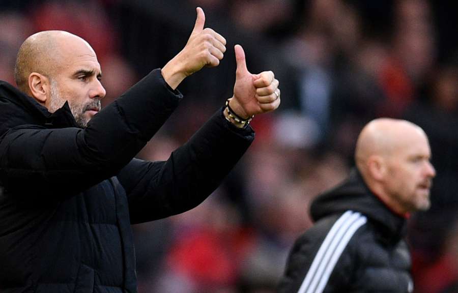 Managers Pep Guardiola and Erik ten Hag react during the English Premier League football match between Manchester United and Manchester City