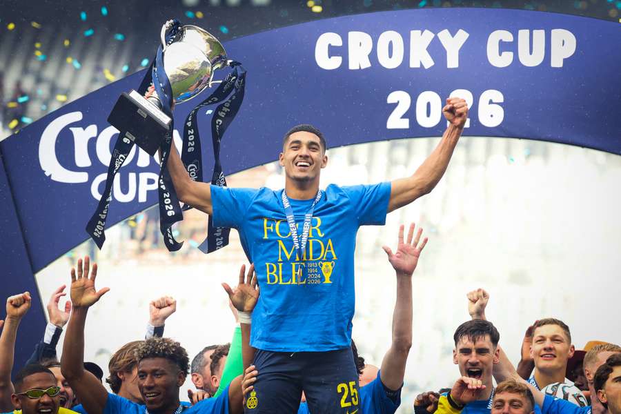 Royale Union Saint-Gilloise's Anan Khalaili raises the trophy after winning the Belgian cup
