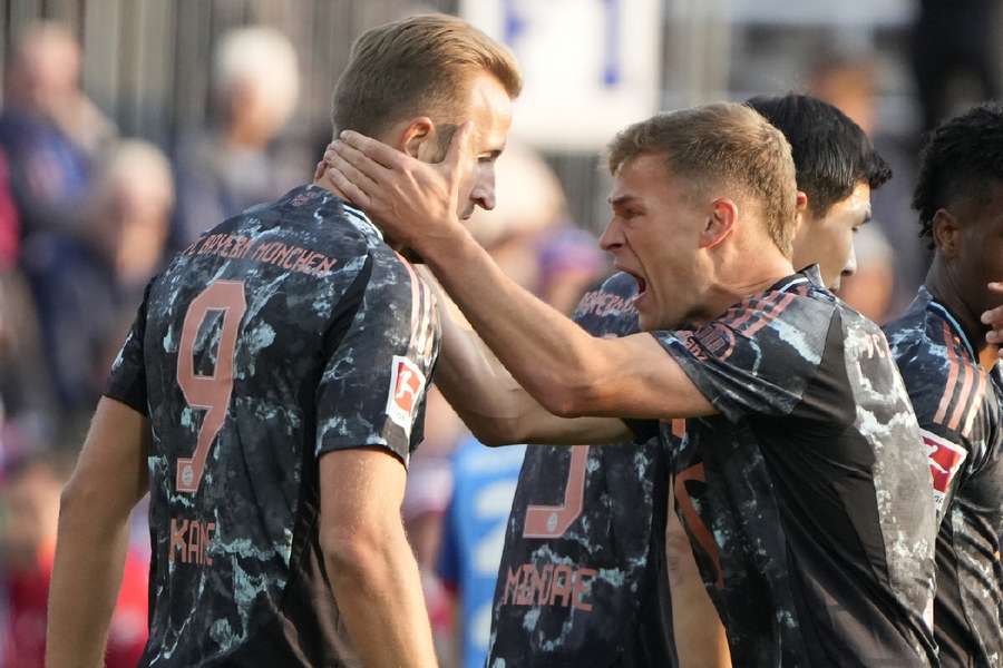 Harry Kane celebrates with teammates after scoring during the German Bundesliga