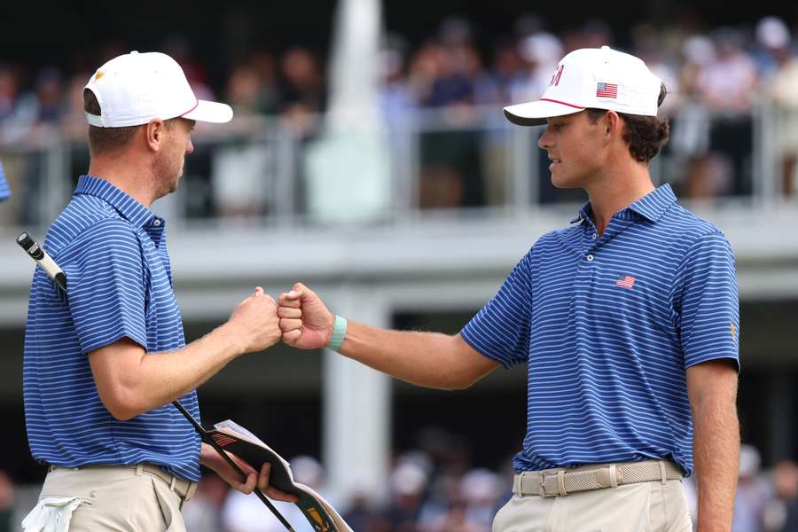 Jackson Koivun (right) of the U.S. Team fist bumps Justin Thomas (left) Jackson Koivun (right) of the U.S. Team fist bumps Justin Thomas (left)