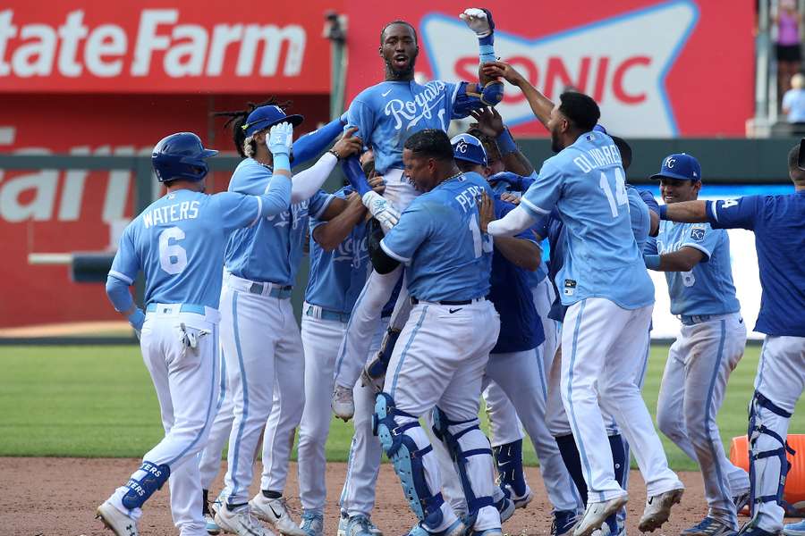 Kansas City Royals left fielder Samad Taylor is lifted in the air by teammates