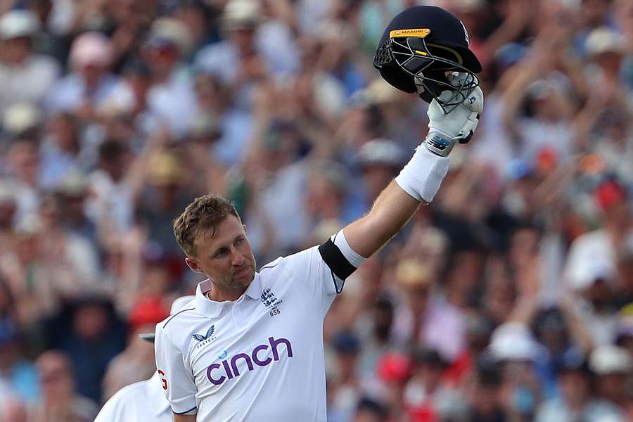 Joe Root celebrates scoring a century on the opening day of the first Ashes cricket Test match