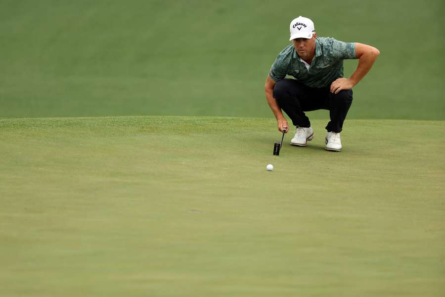 Alex Noren looks over a putt on the second green