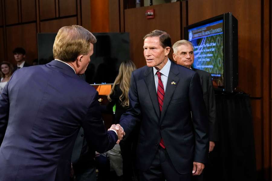 US Senator Richard Blumenthal shakes hands with PGA Tour chief Ron Price during a Senate examining the business deal between the PGA Tour and LIV Golf