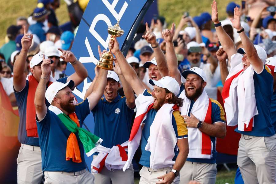 Tommy Fleetwood lifts the Ryder Cup alongside his teammates