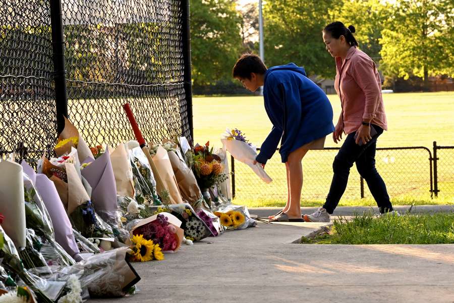 Mourners lay flowers at the cricket nets where 17-year-old Ben Austin was hit whilst batting.  Mourners lay flowers at the cricket nets where 17-year-old Ben Austin was hit whilst batting.