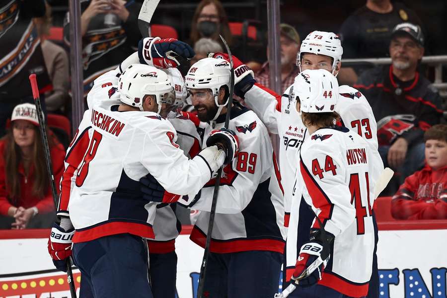 Capitals players surround Alex Tuch (89) after scoring his first goal with the team Capitals players surround Alex Tuch (89) after scoring his first goal with the team
