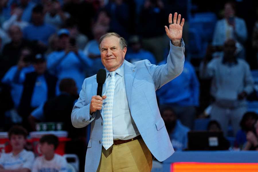 Bill Belichick waves to a crowd of UNC fans before introducing new recruit Bryce Baker