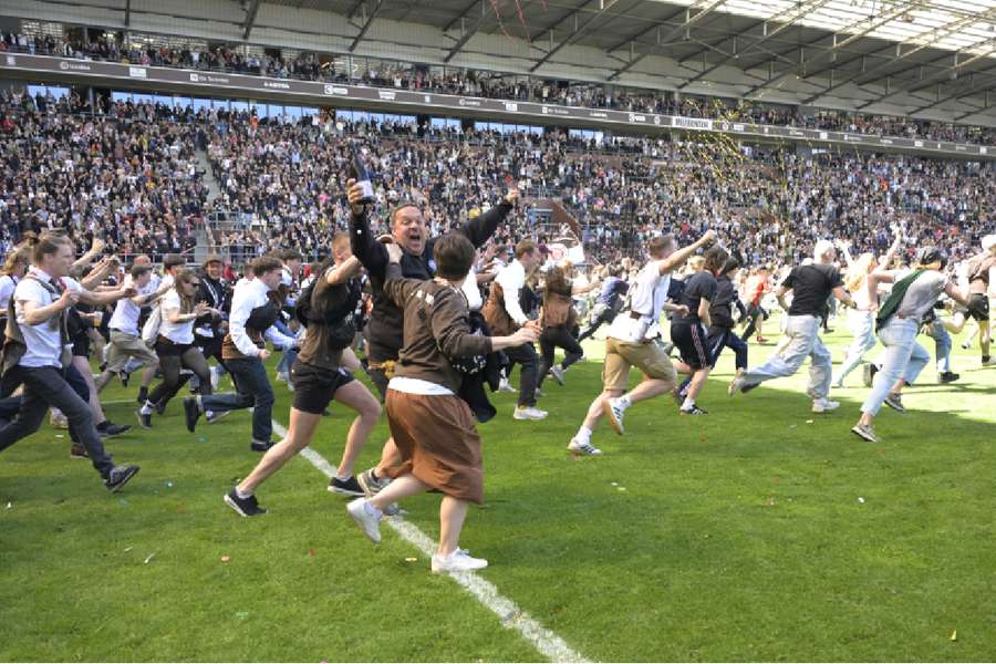 Fans run onto the pitch after St. Pauli secured promotion