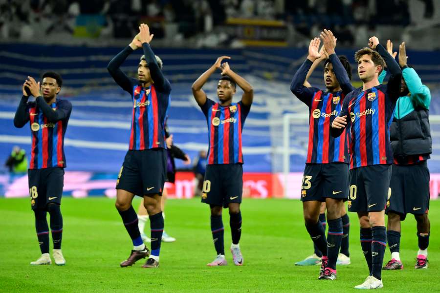 Barcelona's players celebrate in front of the away fans at the final whistle