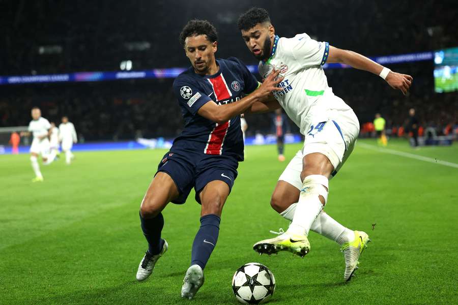 Paris SG's Marquinhos fights for the ball with PSV Eindhoven's Ismael Saibari