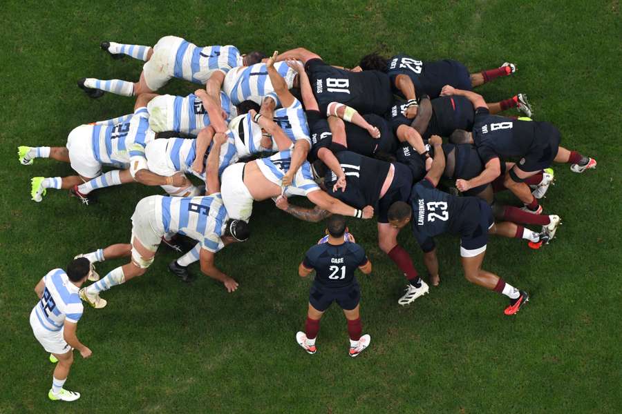 England scrum-half Danny Care (bottom) prepares to feed the ball into the scrum during the World Cup match against Argentina