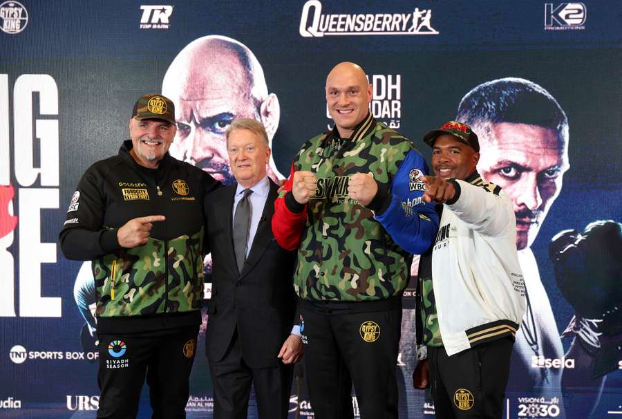 Father of Tyson Fury, John Fury, Frank Warren, Tyson Fury, and SugarHill Steward pose for a photo after a press conference