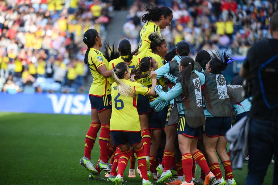 Colombia players celebrate scoring their first goal