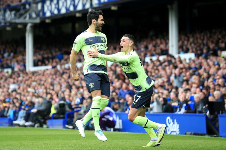 Manchester City midfielder Ilkay Gundogan celebrates with Phil Foden (R) 