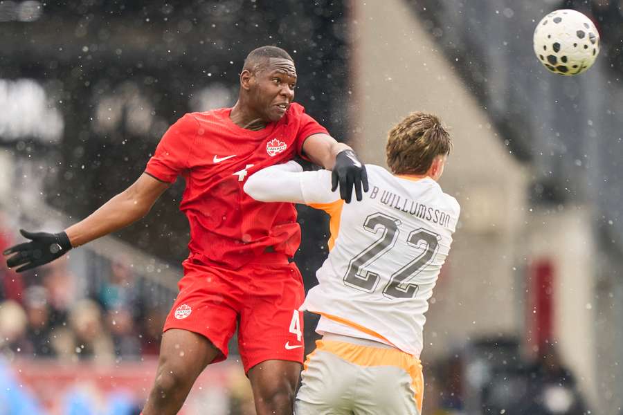 Canada's Kamal Miller and Iceland's Brynjolfur Willumsson battle for the ball