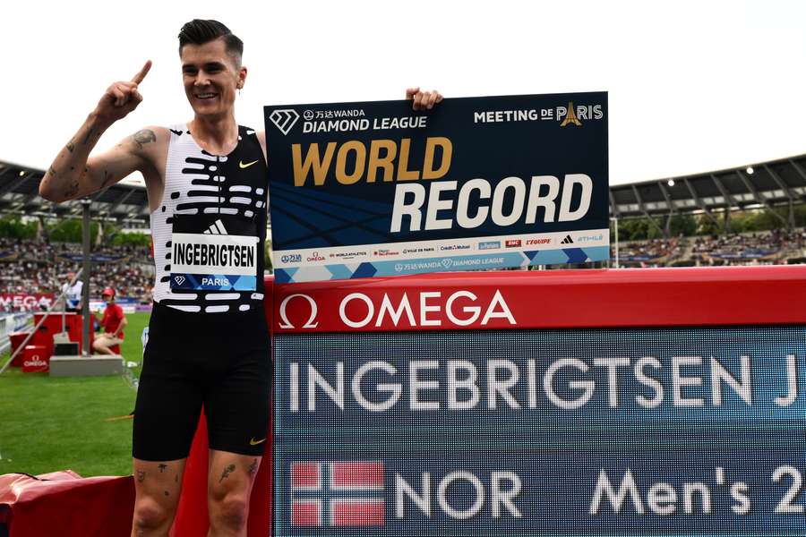 Jakob Ingebrigtsen celebrates after breaking the world record in the men's two mile event at the Diamond League in Paris