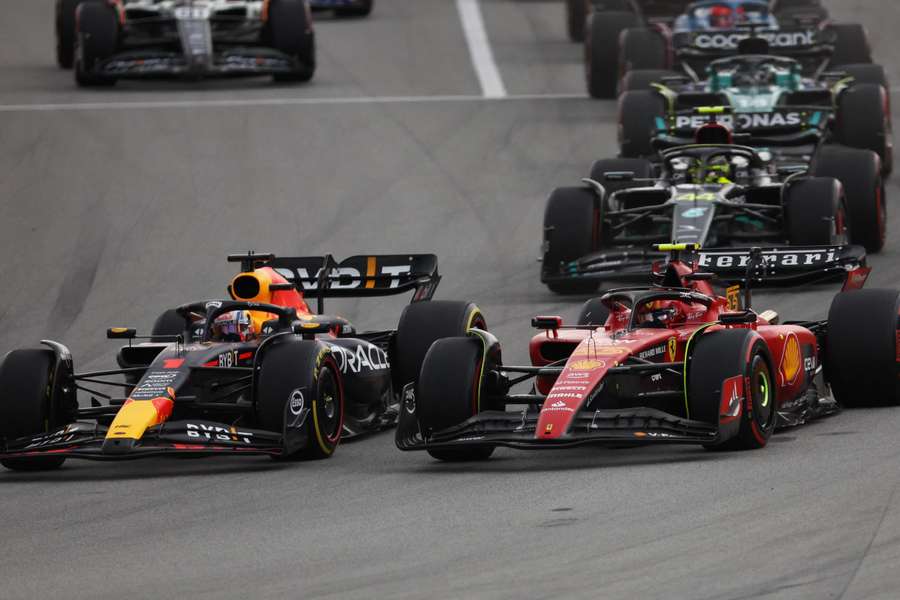 Red Bull's Max Verstappen in action as he leads into the first corner at start of the race ahead of Ferrari's Carlos Sainz 