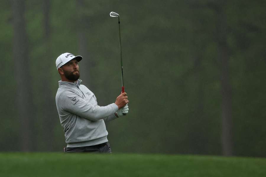 Jon Rahm plays his shot from the 12th tee