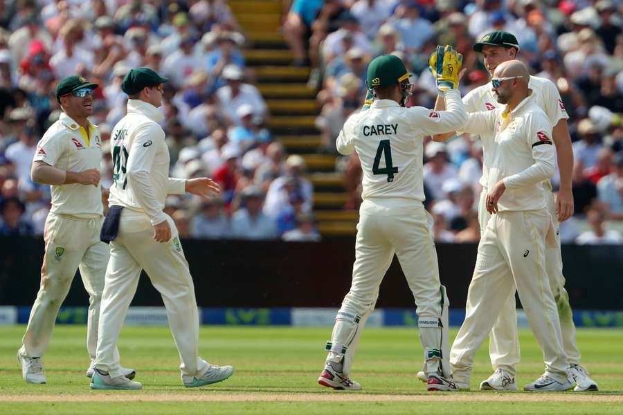 Australia's players celebrate the wicket of England's Jonny Bairstow during play on the opening day