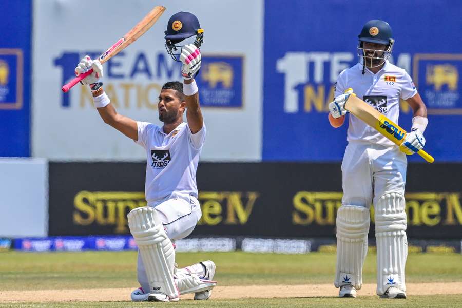 Sri Lanka's Dinesh Chandimal (L) celebrates after scoring a century as Sadeera Samarawickrama watches