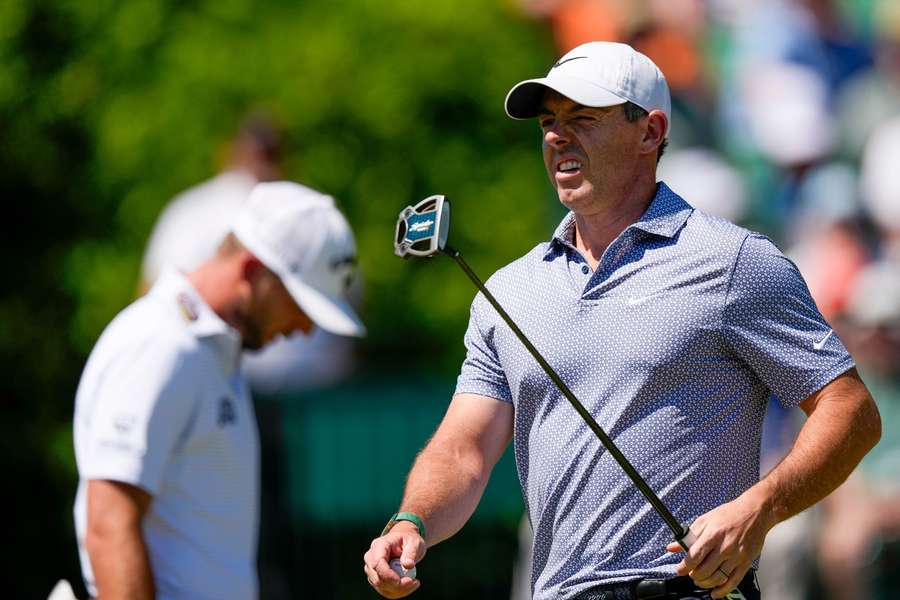 Rory McIlroy charged back late after squandering a six-stroke edge to share the lead with Cameron Young after a wild third round