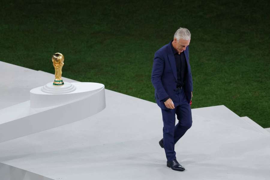 France's Didier Deschamps walks past the World Cup trophy after defeat to Argentina