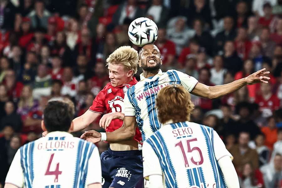Loic Nego, right, heads the ball next to Lille's Icelandic midfielder Hakon Arnar Haraldsson 