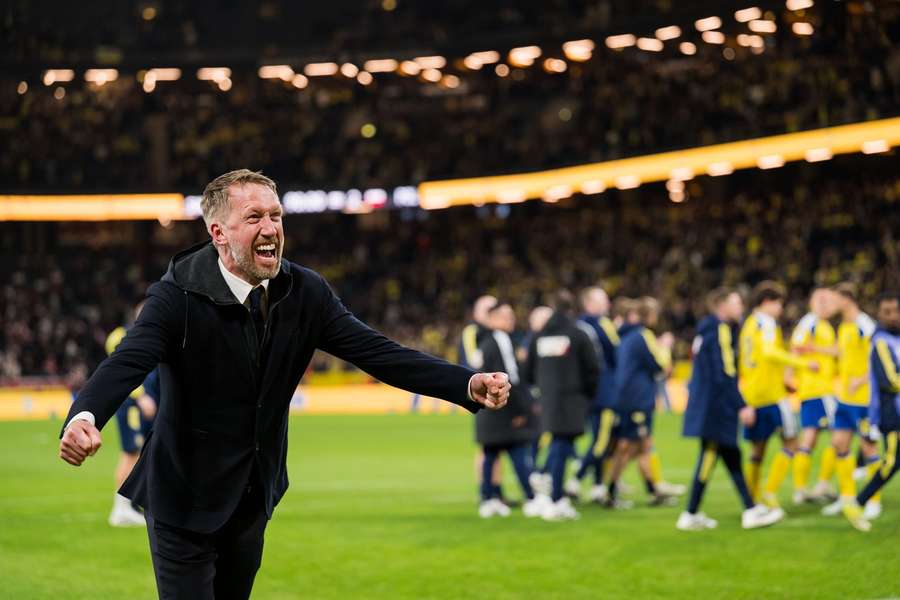 Graham Potter celebrates with the Sweden fans at full-time