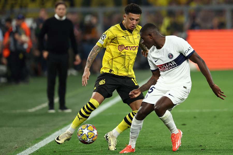 Borussia Dortmund midfielder Jadon Sancho (L) and Paris Saint-Germain defender Nuno Mendes vie for the ball