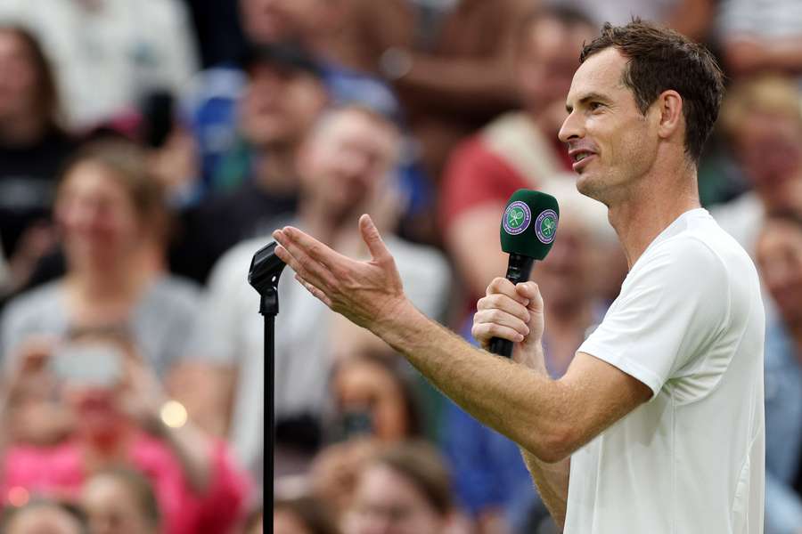 Britain's Andy Murray addresses Switzerland's former tennis player Roger Federer after winning his men's singles tennis match against Britain's Ryan Peniston on the second day