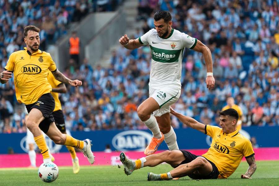 Elche's Rafa Mir is tackled by Espanyol's Ruben Sanchez and Fernando Calero Elche's Rafa Mir is tackled by Espanyol's Ruben Sanchez and Fernando Calero