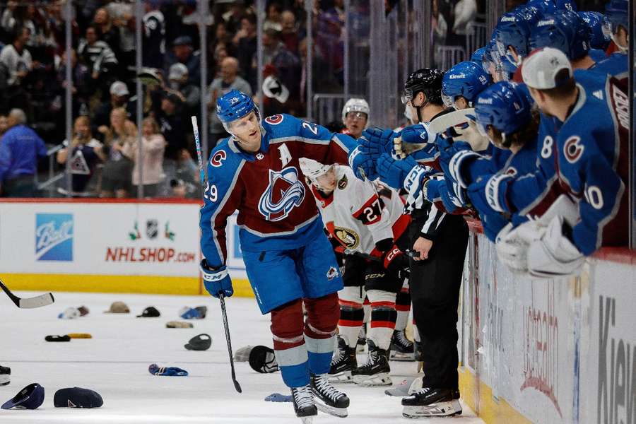 Nathan MacKinnon celebrates his hat-trick goal with the bench