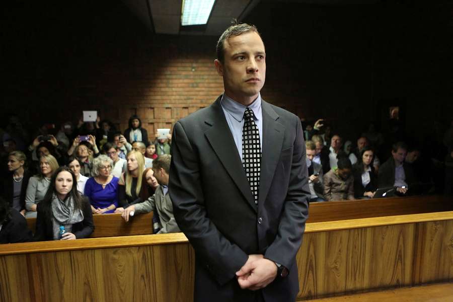 Pistorius enters the dock before court proceedings during his 2013 trial