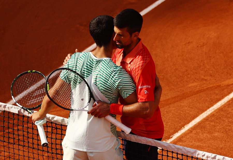 Djokovic and Alcaraz embrace after the match