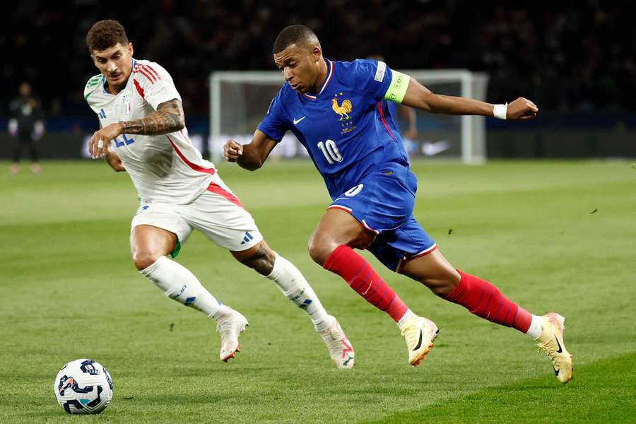 Kylian Mbappe (right) in action with Italy's Giovanni Di Lorenzo