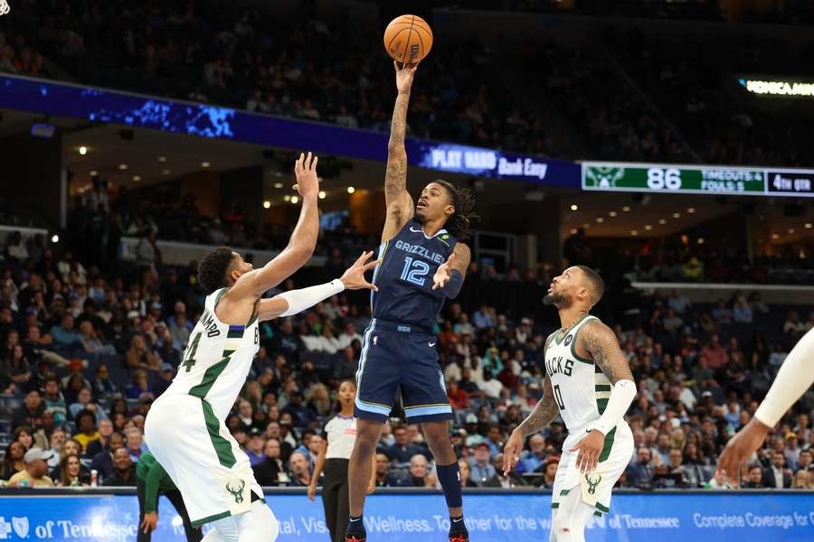 Ja Morant shoots the ball over Giannis Antetokounmp