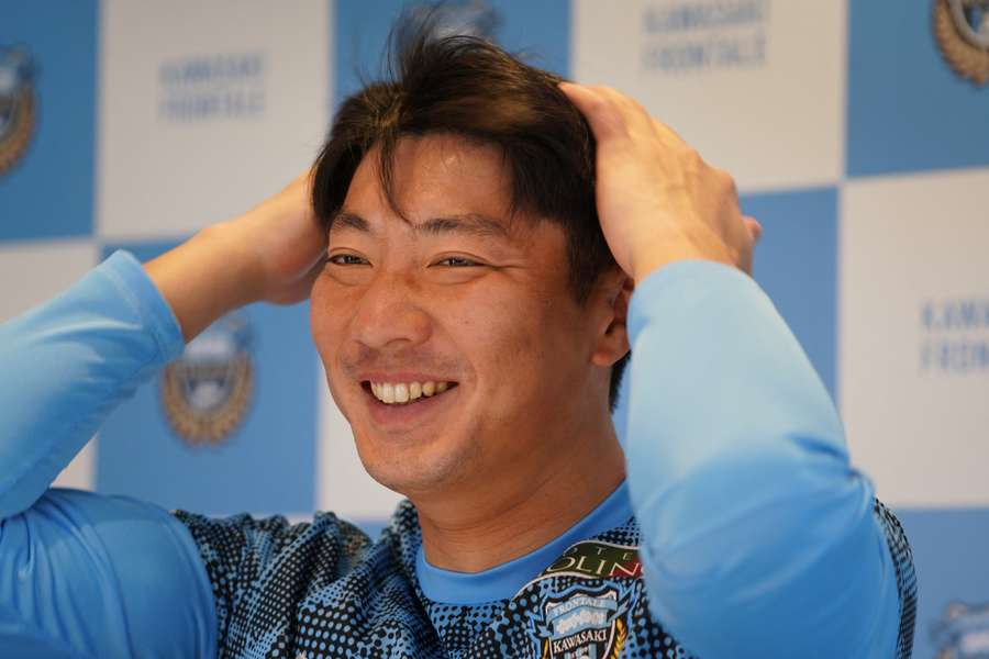 Kawasaki Frontale's goalkeeper Shunsuke Ando smiles and answers questions during an AFP interview in the team's clubhouse
