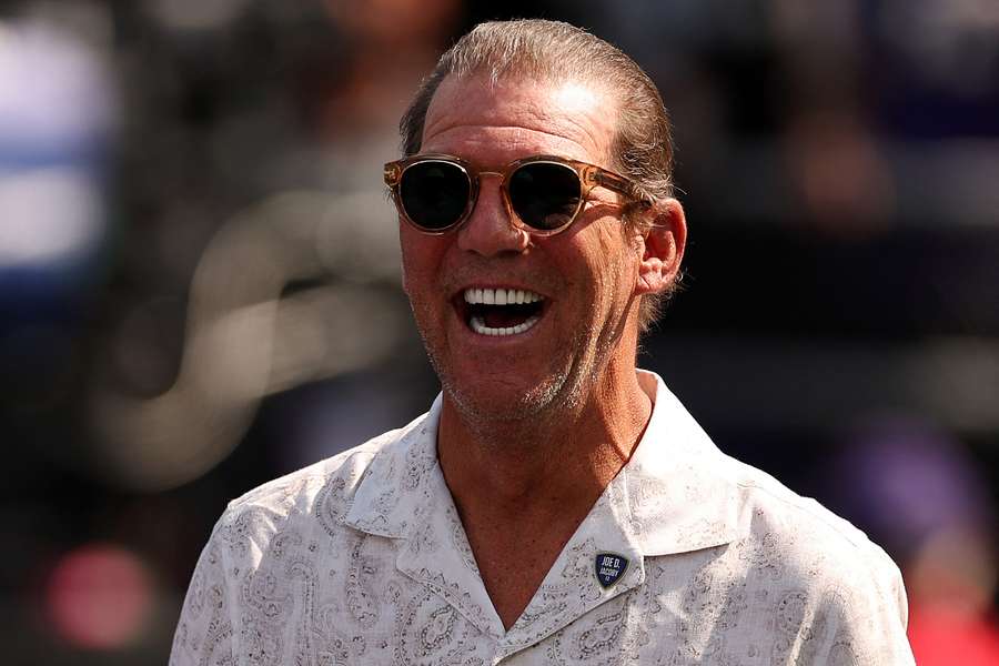 Baltimore Ravens owner and multi-billionaire Steve Bisciotti smiling on the field before a game. (2024)