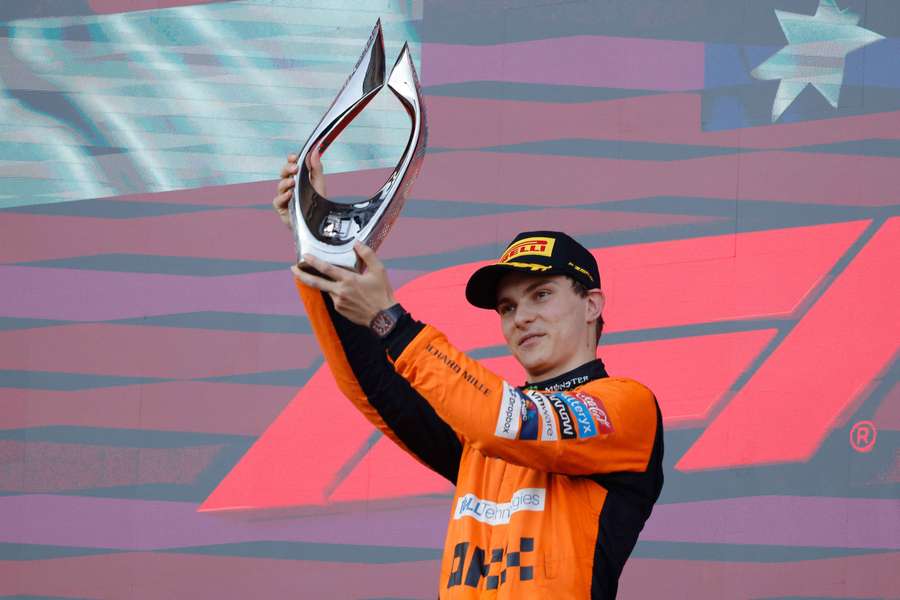 McLaren's Oscar Piastri celebrates with a trophy on the podium after winning the Azerbaijan Grand Prix