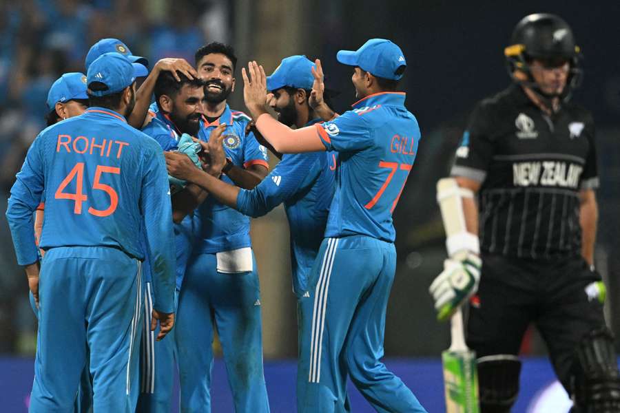 India's Mohammed Shami celebrates with teammates after taking the wicket of New Zealand's Tom Latham