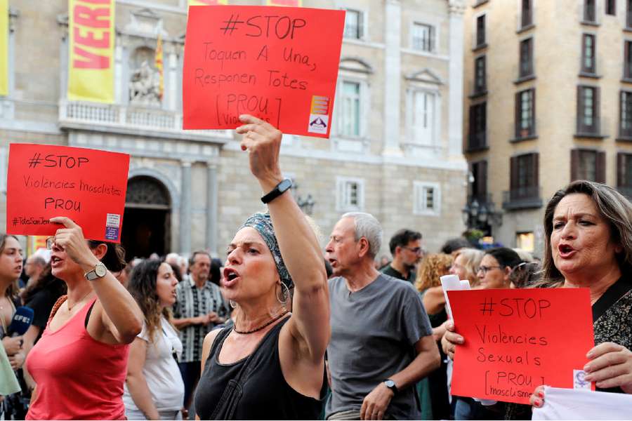 Women hold placards, depicting red cards in football, that read "Stop Violence against Women" during a protest against Rubiales