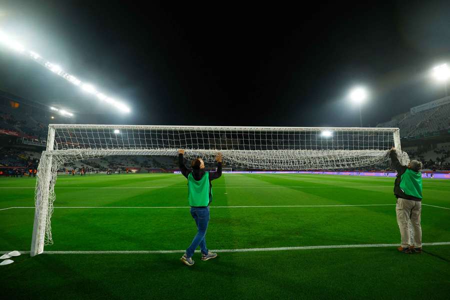 Groundstaff roll up the goal net after the match was postponed
