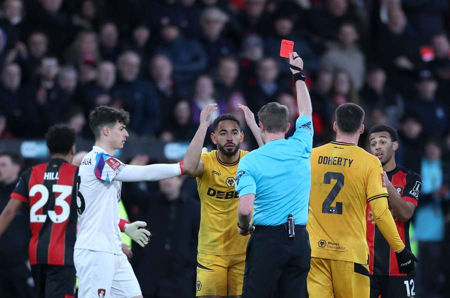 Matheus Cunha reacts after receiving a red card