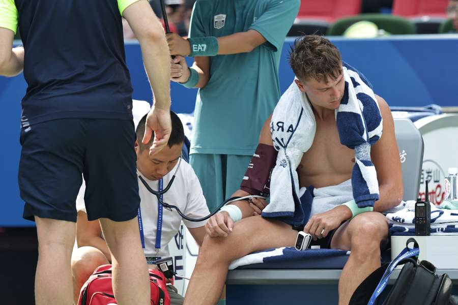 Holger Rune receives treatment during the Shanghai Masters