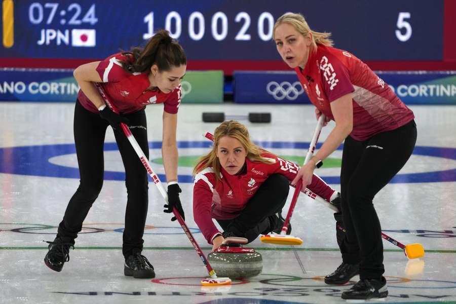 Denmark's Madeleine Dupont, Denise Dupont, and Jasmin Holtermann in action during the women's curlingmatch against Japan