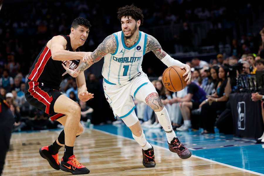 Hornets LaMelo Ball (right) dribbles during 2026 NBA play-in tournament