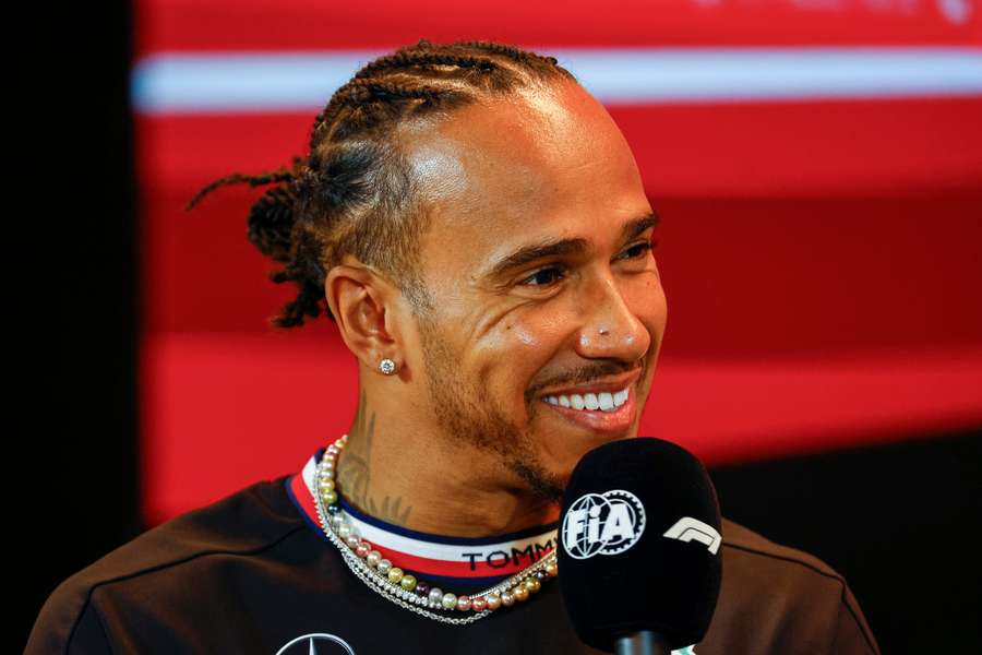 Lewis Hamilton laughs during a preview press conference