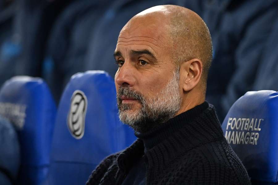 Pep Guardiola takes his seat ahead of Man City's defeat at Brighton on Saturday